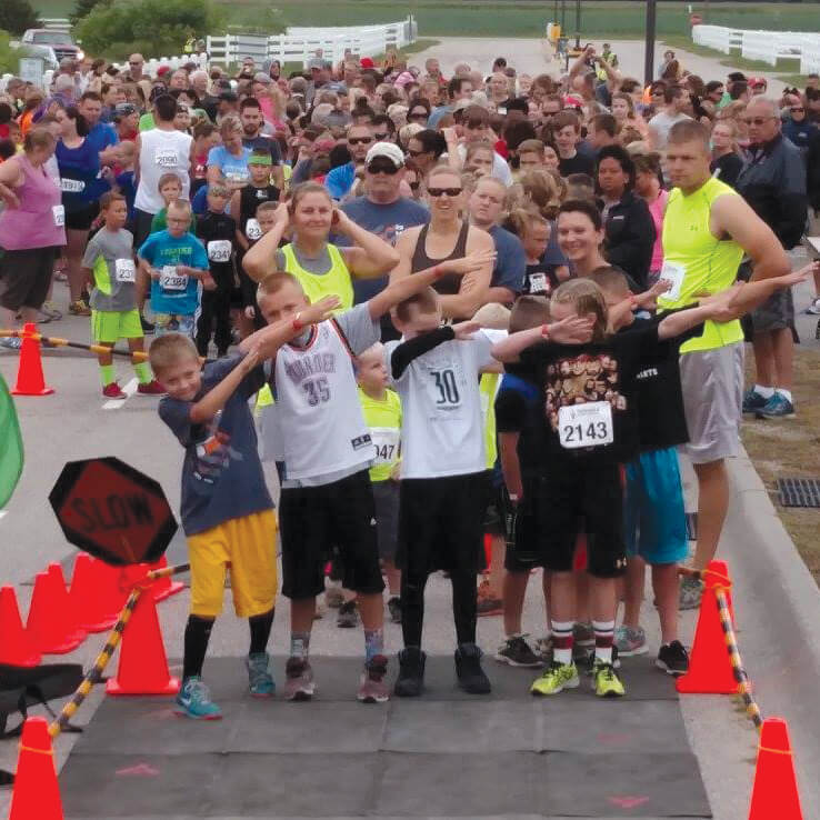 A group of young boys poses at the starting line of the annual Mud Run event hosted at Sandhills Global Event Center.